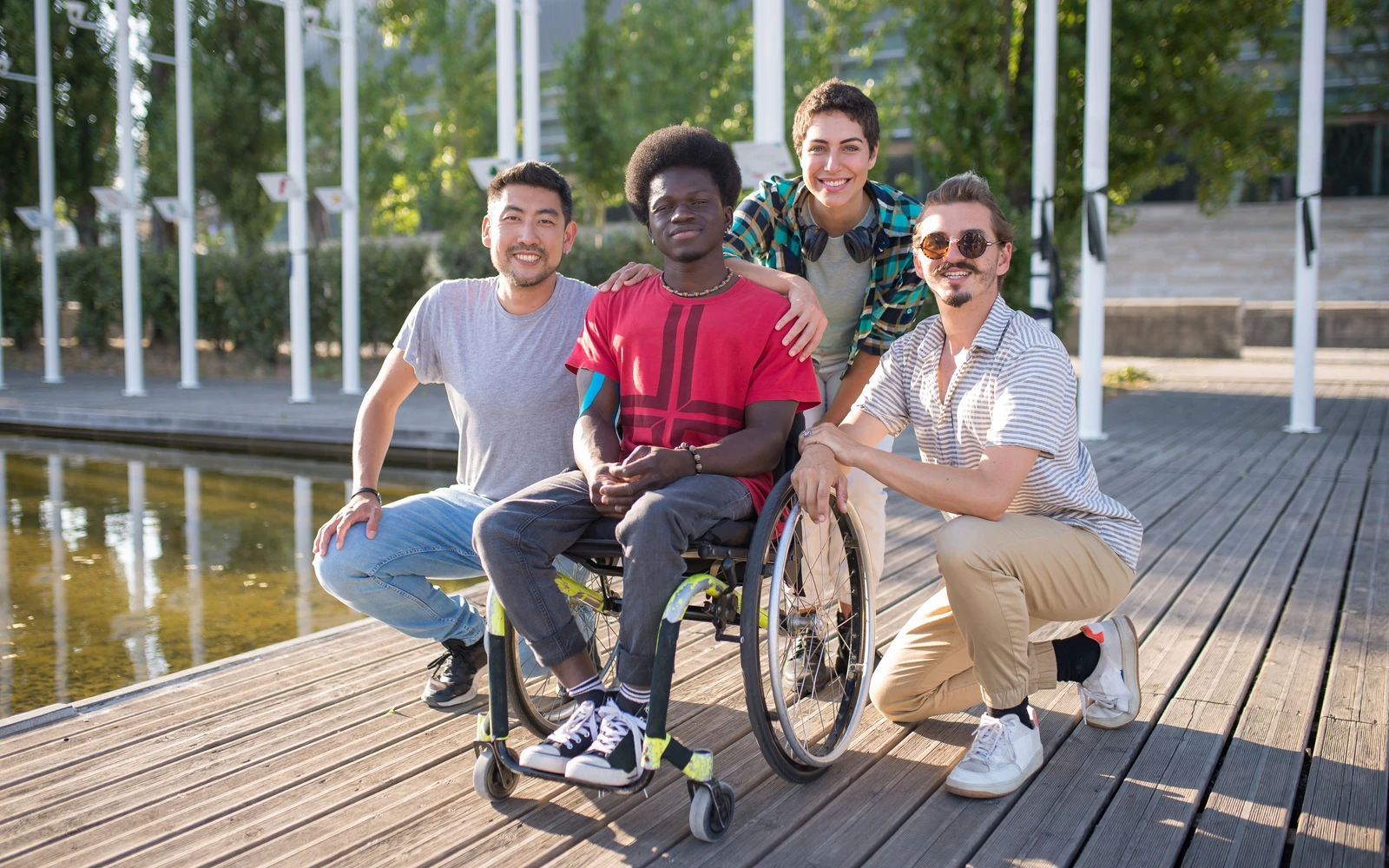 Friends together outdoors, including a wheelchair user